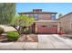 Charming two-story home featuring a stone-accented garage, desert landscaping, and a welcoming entrance at 6523 S 34Th Dr, Phoenix, AZ 85041