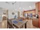 Kitchen featuring an island, stainless steel appliances, dining area, and staircase at 6523 S 34Th Dr, Phoenix, AZ 85041