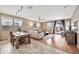 Open-concept living area with wood flooring, a dining table, and a sliding door to the patio at 6523 S 34Th Dr, Phoenix, AZ 85041