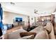 Bright living room featuring hardwood floors, a large sectional, and an entertainment center at 6523 S 34Th Dr, Phoenix, AZ 85041