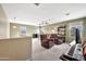 Large open living space showcasing cozy chairs, ceiling fans, and neutral carpet, creating a welcoming atmosphere at 6523 S 34Th Dr, Phoenix, AZ 85041