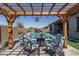 Outdoor living space with a pool, hot tub, and pergola-shaded seating area at 7250 N 80Th Ln, Glendale, AZ 85303