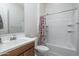 Full bathroom with a shower over bath and cherry-wood vanity at 7250 N 80Th Ln, Glendale, AZ 85303