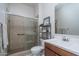 Bathroom featuring a tiled walk-in shower and a wood vanity at 7250 N 80Th Ln, Glendale, AZ 85303