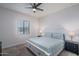 Bright bedroom with a ceiling fan and two bedside tables with lamps at 7250 N 80Th Ln, Glendale, AZ 85303