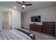 Comfortable bedroom featuring a ceiling fan, TV, and dark wood dresser at 7250 N 80Th Ln, Glendale, AZ 85303