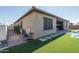 Exterior view featuring artificial grass, a patio, and a swimming pool at 7250 N 80Th Ln, Glendale, AZ 85303