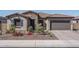 Charming single-story home featuring a stone facade, tile roof, and well-maintained landscaping in a desirable neighborhood at 7250 N 80Th Ln, Glendale, AZ 85303