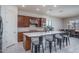 Modern kitchen with a large center island, stainless steel appliances, and stylish pendant lighting overlooking the dining area at 7250 N 80Th Ln, Glendale, AZ 85303