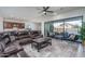 Inviting living room with large windows, a comfortable leather sectional, and seamless access to the outdoor living space at 7250 N 80Th Ln, Glendale, AZ 85303