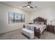 Serene main bedroom features a ceiling fan, carpeted floors, and a large window, creating a peaceful retreat at 7250 N 80Th Ln, Glendale, AZ 85303