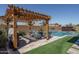 Backyard pergola with outdoor seating and grill overlooking the pool at 7250 N 80Th Ln, Glendale, AZ 85303