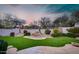 Beautiful backyard featuring artificial grass, a small waterfall, and desert landscaping at 7722 E Fledgling Dr, Scottsdale, AZ 85255