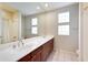 Bathroom featuring double sinks, a large mirror, and ample lighting at 7722 E Fledgling Dr, Scottsdale, AZ 85255