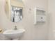 Powder room with a pedestal sink, round mirror, and storage providing functionality at 833 W Cholla St, Casa Grande, AZ 85122