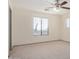 A simple bedroom with neutral carpet and ceiling fan offering a calming retreat at 833 W Cholla St, Casa Grande, AZ 85122