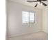 A bright bedroom with carpet, a ceiling fan, and a window that offers views and lets in natural light at 833 W Cholla St, Casa Grande, AZ 85122