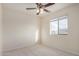 An inviting bedroom with neutral carpet, a ceiling fan, and a window providing natural light at 833 W Cholla St, Casa Grande, AZ 85122