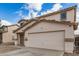 Two-story home with neutral color scheme and tile roof, featuring a front entrance and a two car garage at 833 W Cholla St, Casa Grande, AZ 85122