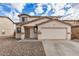 Charming two-story home with a large two car garage, neutral color scheme and low maintenance gravel yard at 833 W Cholla St, Casa Grande, AZ 85122