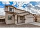 Two-story home with neutral color scheme and tile roof, featuring a front entrance and a two car garage at 833 W Cholla St, Casa Grande, AZ 85122