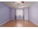 Bedroom features light, a ceiling fan, and large window at 9231 N 111Th Ave, Sun City, AZ 85351