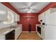 Charming kitchen offering wood floors and red accent wall at 9231 N 111Th Ave, Sun City, AZ 85351