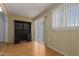 Functional room featuring wood flooring, built-in shelves, and a sliding glass door to let in natural light at 9231 N 111Th Ave, Sun City, AZ 85351