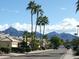 Neighborhood street view featuring mature landscaping and stunning mountain views in the background at 9296 E Karen Dr, Scottsdale, AZ 85260