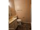 A functional bathroom featuring a toilet, single sink vanity, and tile flooring at 10112 N 96Th Ave # A, Peoria, AZ 85345