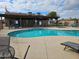 Community pool area with lounge chairs, a spa and covered seating by the pool at 10112 N 96Th Ave # A, Peoria, AZ 85345