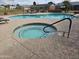 Sparkling community pool and hot tub, surrounded by lounge seating and secure fencing at 10112 N 96Th Ave # A, Peoria, AZ 85345