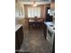 Warm dining area adjacent to the kitchen featuring tiled floors and a window, offering ample natural light at 10112 N 96Th Ave # A, Peoria, AZ 85345