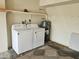 Functional laundry area with a washer, dryer, and storage shelf, providing convenience for laundry needs at 10112 N 96Th Ave # A, Peoria, AZ 85345