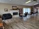 A lounge area with a brick fireplace, sofa, and reading area with tables and chairs at 10112 N 96Th Ave # A, Peoria, AZ 85345