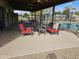 Spacious covered patio featuring stylish outdoor furniture and a view of the community pool at 10112 N 96Th Ave # A, Peoria, AZ 85345