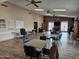 Bright recreation room with ceiling fans, tables, chairs, and access to outdoor amenities at 10112 N 96Th Ave # A, Peoria, AZ 85345
