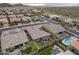 Aerial view of neighborhood homes with pools and solar panels and well-kept lawns in a desert landscape at 10246 W Oberlin Way, Peoria, AZ 85383