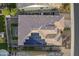 An aerial view shows solar panels on the roof, and a cozy backyard setup at 10246 W Oberlin Way, Peoria, AZ 85383