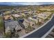 An aerial view shows mountain views, desert landscaping, solar panels, and tidy streets in a residential community at 10246 W Oberlin Way, Peoria, AZ 85383