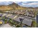 Bird's eye view of a desert community featuring homes with pools, mountain views, and solar panels at 10246 W Oberlin Way, Peoria, AZ 85383