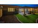 Inviting backyard with artificial grass, a covered patio, and a well-maintained landscape at 10246 W Oberlin Way, Peoria, AZ 85383