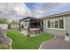 A backyard with artificial turf, desert landscaping, covered patio, and hot tub at 10246 W Oberlin Way, Peoria, AZ 85383