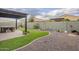 This backyard is decorated with desert landscaping, artificial turf and a spa with a pergola at 10246 W Oberlin Way, Peoria, AZ 85383