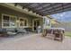 This covered patio has outdoor seating, stainless BBQ grill, and a hot tub, all surrounded by a green lawn at 10246 W Oberlin Way, Peoria, AZ 85383