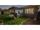 Manicured backyard boasts a covered patio, lush synthetic grass, and low-maintenance desert landscaping at 10246 W Oberlin Way, Peoria, AZ 85383