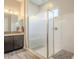 Bright bathroom features a shower with glass enclosure and a modern sink and vanity at 10246 W Oberlin Way, Peoria, AZ 85383