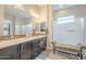 Bright bathroom features double sinks with tile backsplash, a frosted glass shower and a bench at 10246 W Oberlin Way, Peoria, AZ 85383