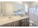 Bathroom features a large mirror, modern vanity, and a shower-tub combination at 10246 W Oberlin Way, Peoria, AZ 85383