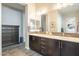 Bright bathroom features double sinks with tile backsplash and dark wood cabinets at 10246 W Oberlin Way, Peoria, AZ 85383